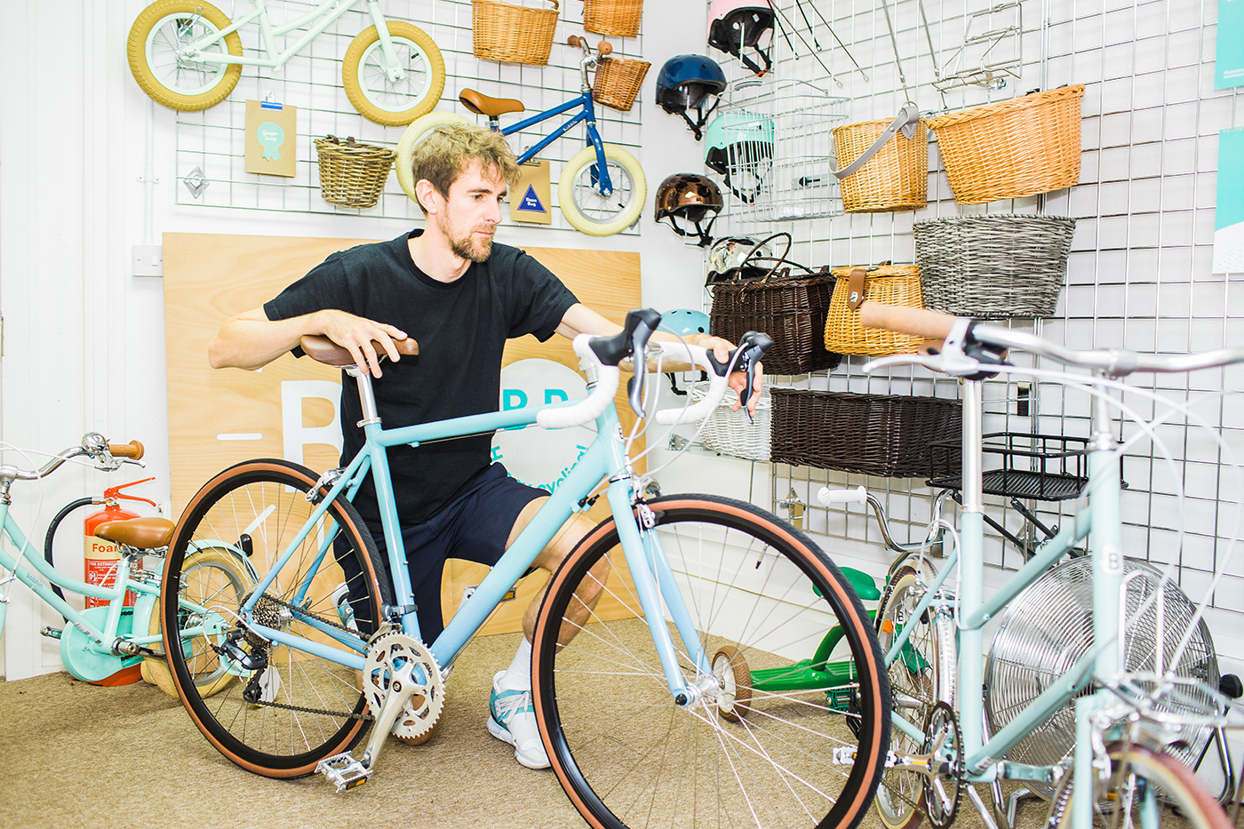 A business owner taking care of a bicicle in a bike shop